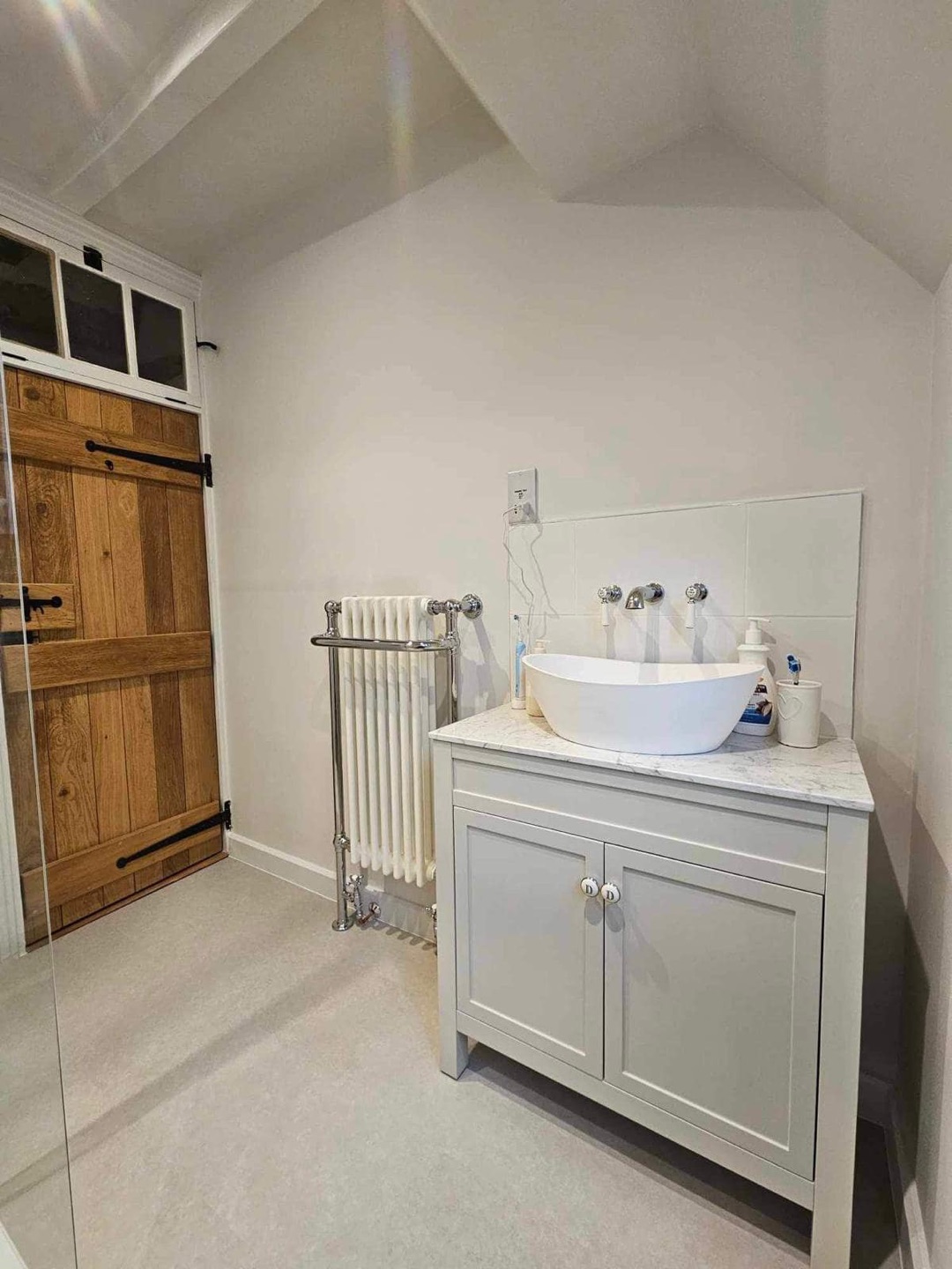 Bathroom renovation with oak door and vanity unit by Constructs