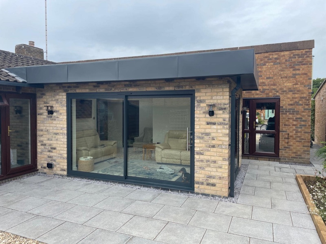 Rear extension with patio area completed in Prestbury by Constructs